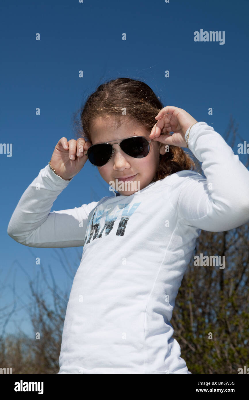 Young girl wearing Ray ban aviator sunglasses outdoor Stock Photo