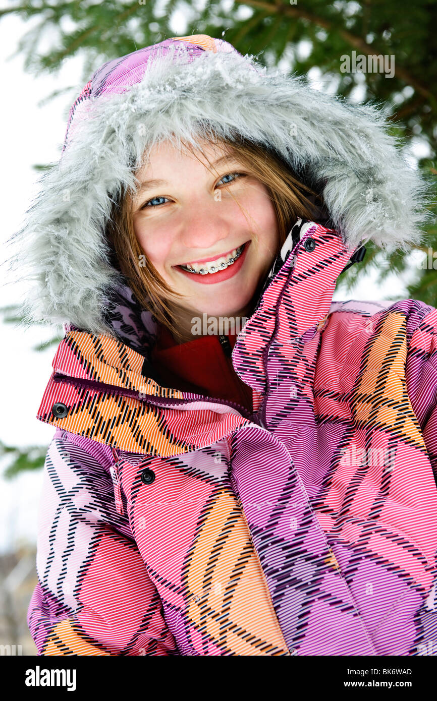 Portrait of happy teenage girl in winter ski coat with fur hood Stock Photo