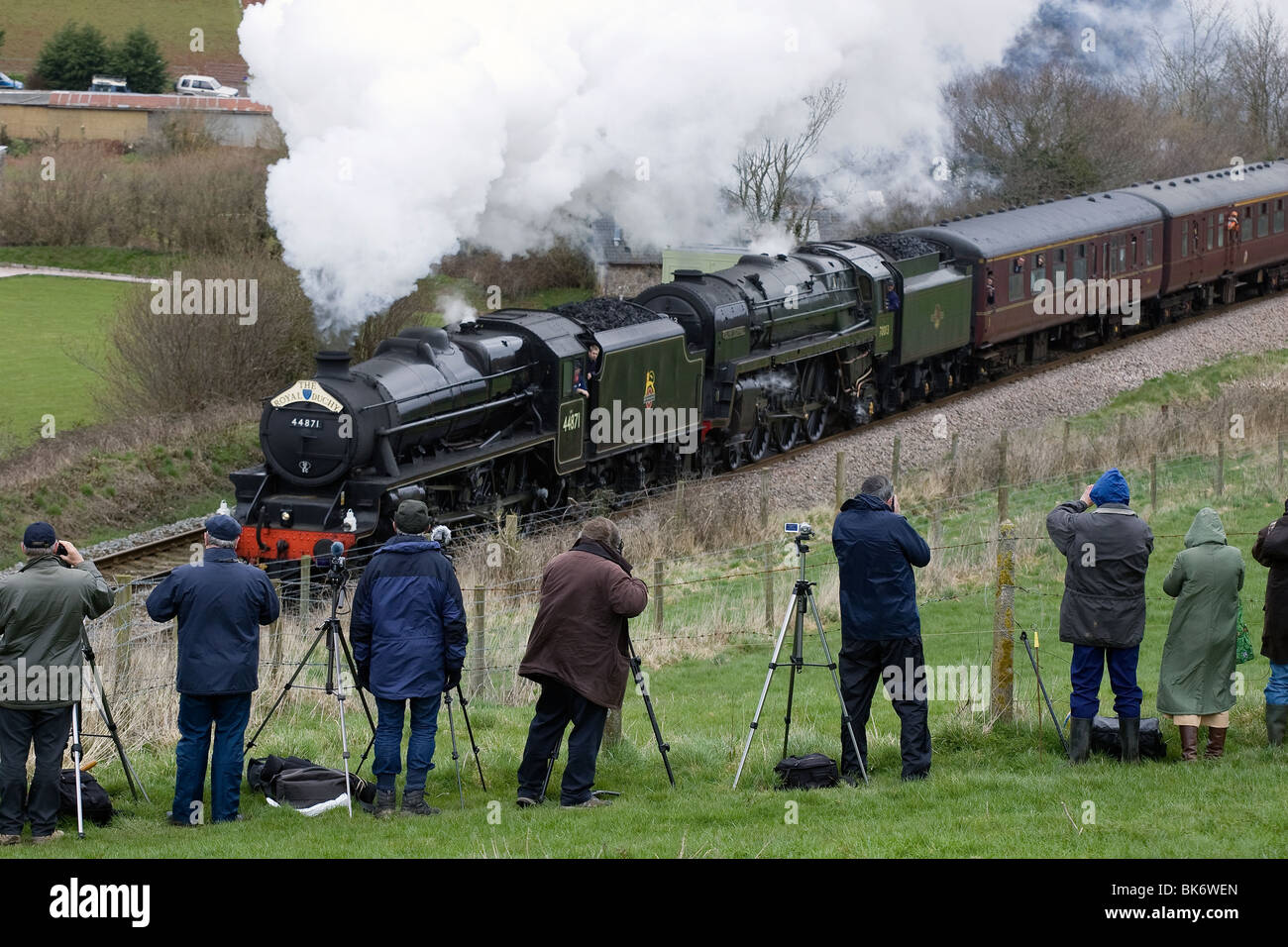 Trainspotters watching a steam train climbing Dainton bank in Devon. Stock Photo
