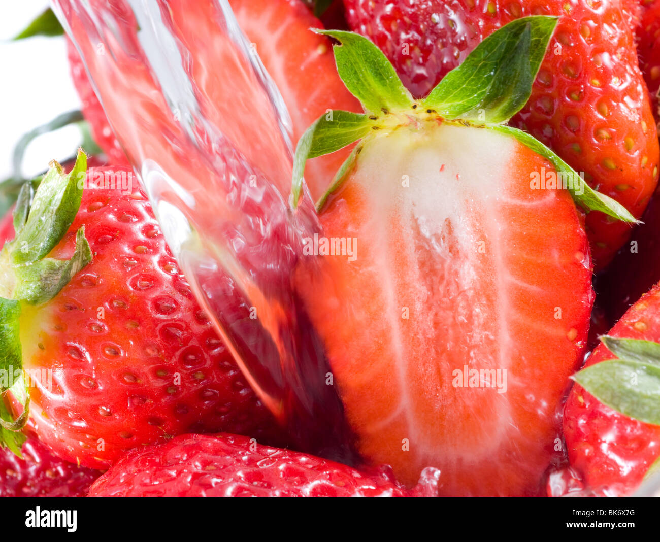 Strawberry falling in juice Stock Photo Alamy