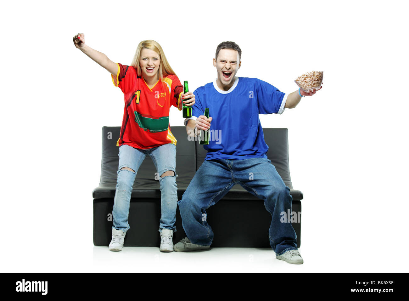 Excited man and woman watching sport isolated on white background Stock Photo