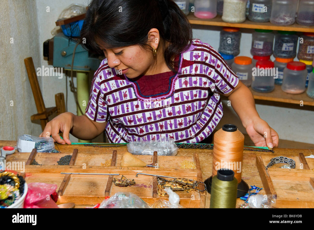 Indigenous female workers making handmade jewelery  from beads Santiago de Atitlan Guatemala Stock Photo