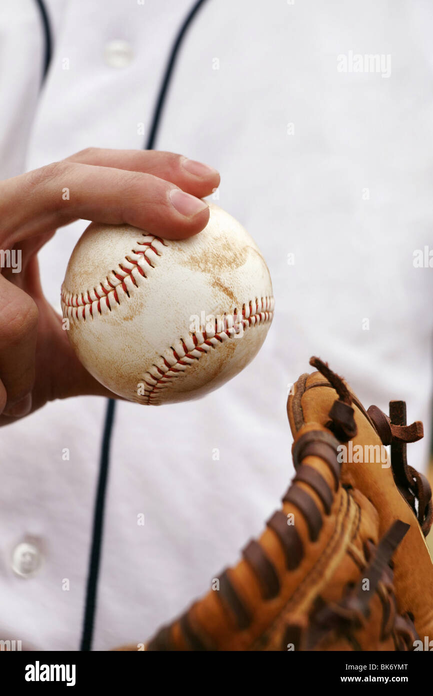 Pitcher showing how to grip the baseball Stock Photo Alamy