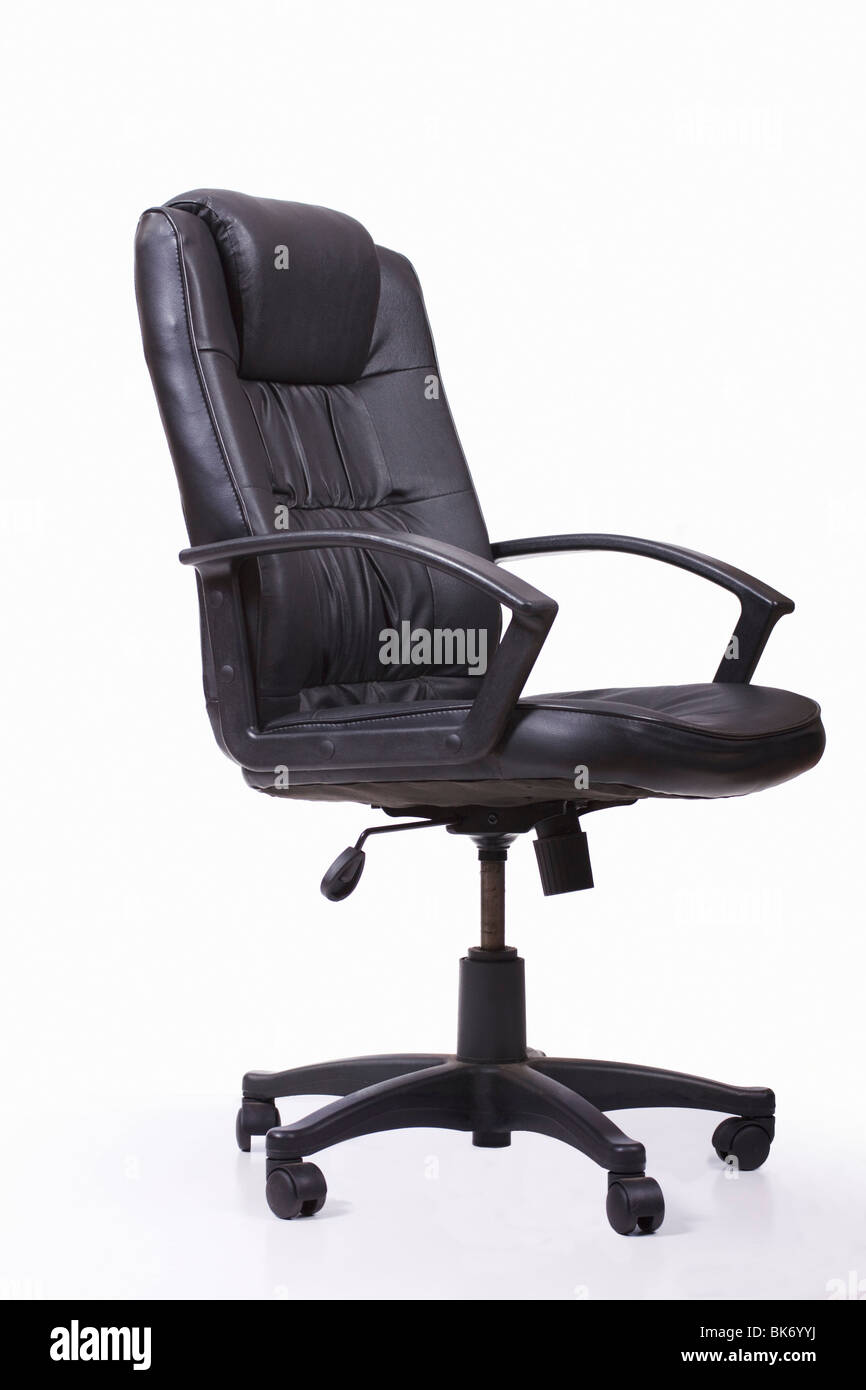 Black leather swivel and tilt office chair on castors. Isolated. Stock Photo