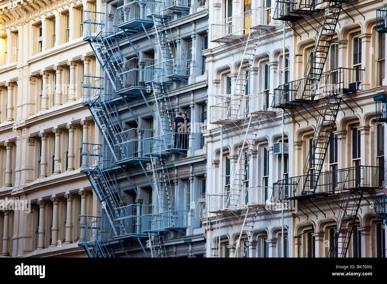 Two men on a fire escape in Soho in New York City Stock Photo
