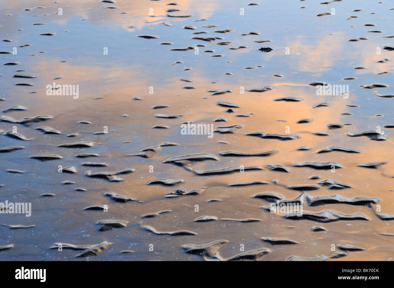 Reflections of sunset clouds, Red Wharf bay, Anglesey, Wales Stock Photo