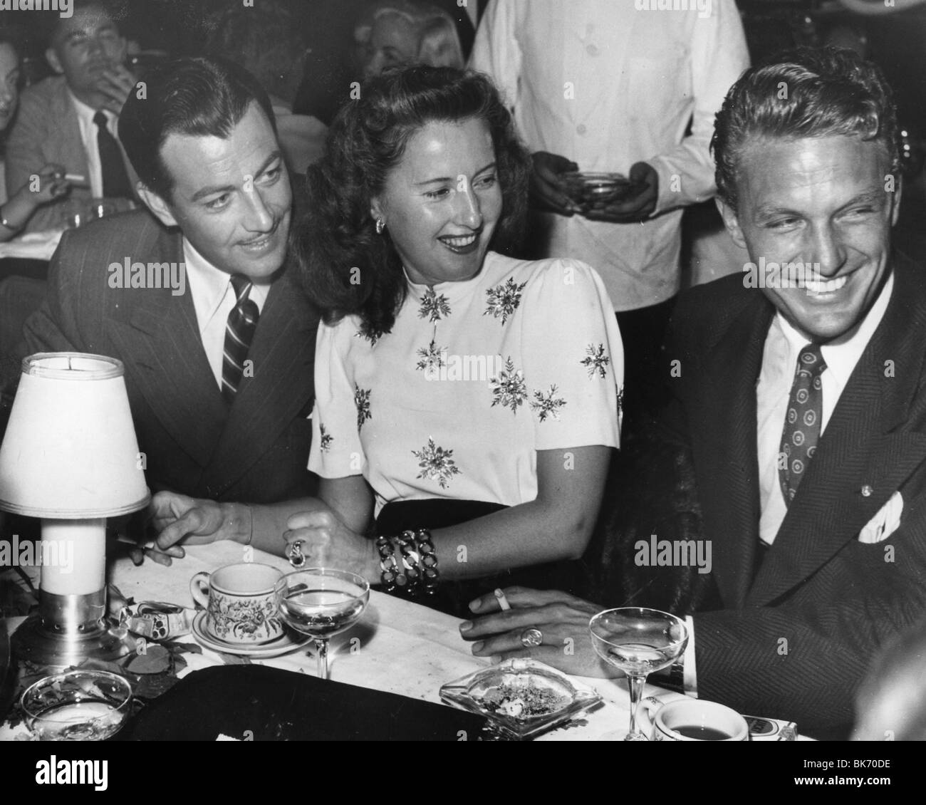 BARBARA STANWYCK - US film actress about 1950 with Robert Taylor at left and Robert Stack Stock Photo