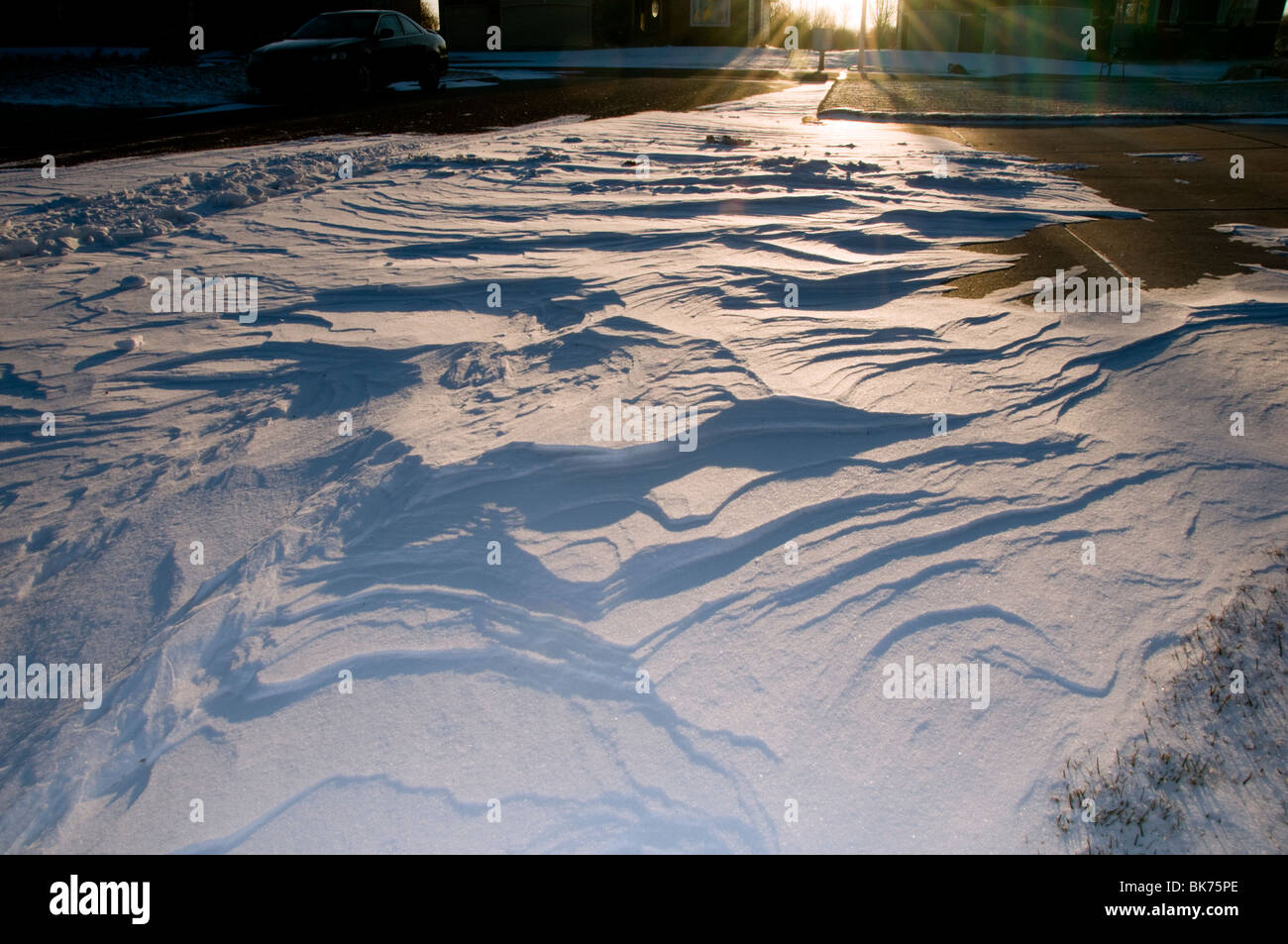 Wind driven patterns of snow in a street after blizzard conditions in Wichita, Kansas, USA. Stock Photo