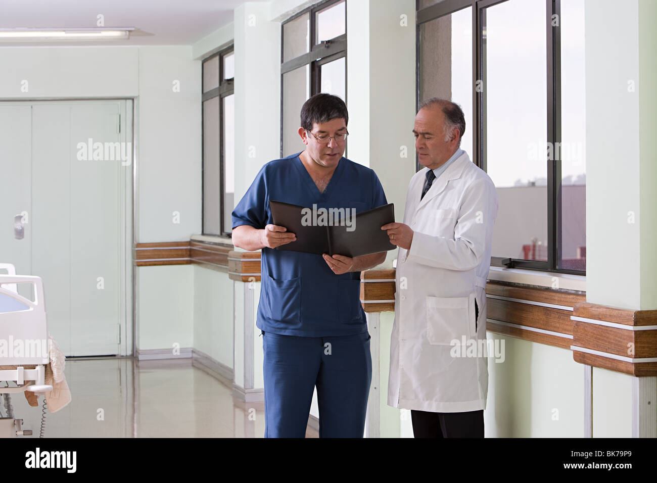 Doctor and surgeon looking at file Stock Photo