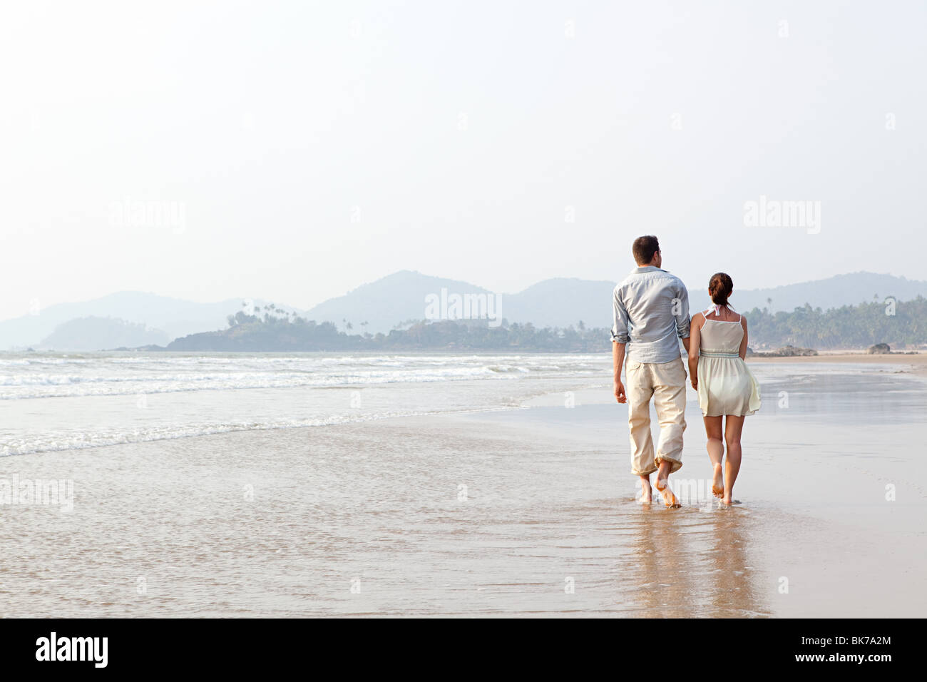 Couple walking in the sea Stock Photo - Alamy