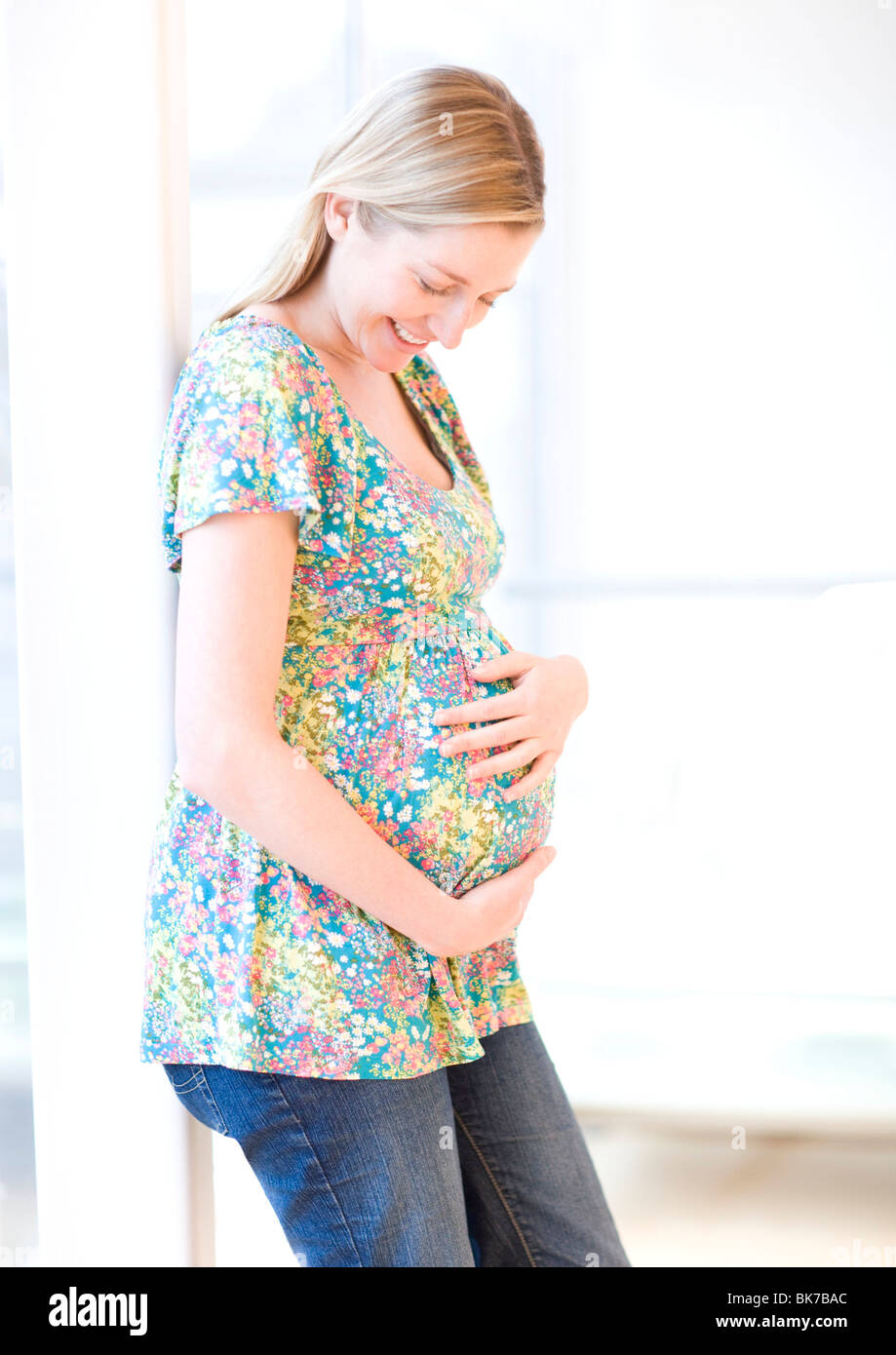 Standing pregnant woman holding hi-res stock photography and images - Alamy