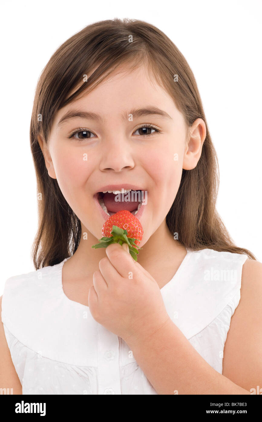 Girl eating a strawberry Stock Photo
