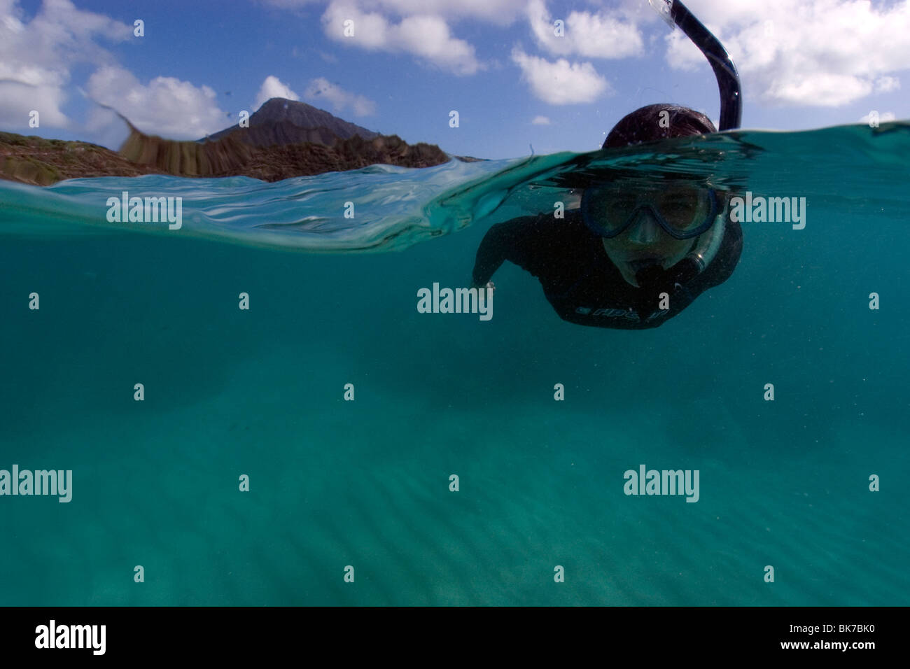 Split image of snorkeler hovering over sandy substrate, Hanauma Bay, Oahu, Hawaii Stock Photo