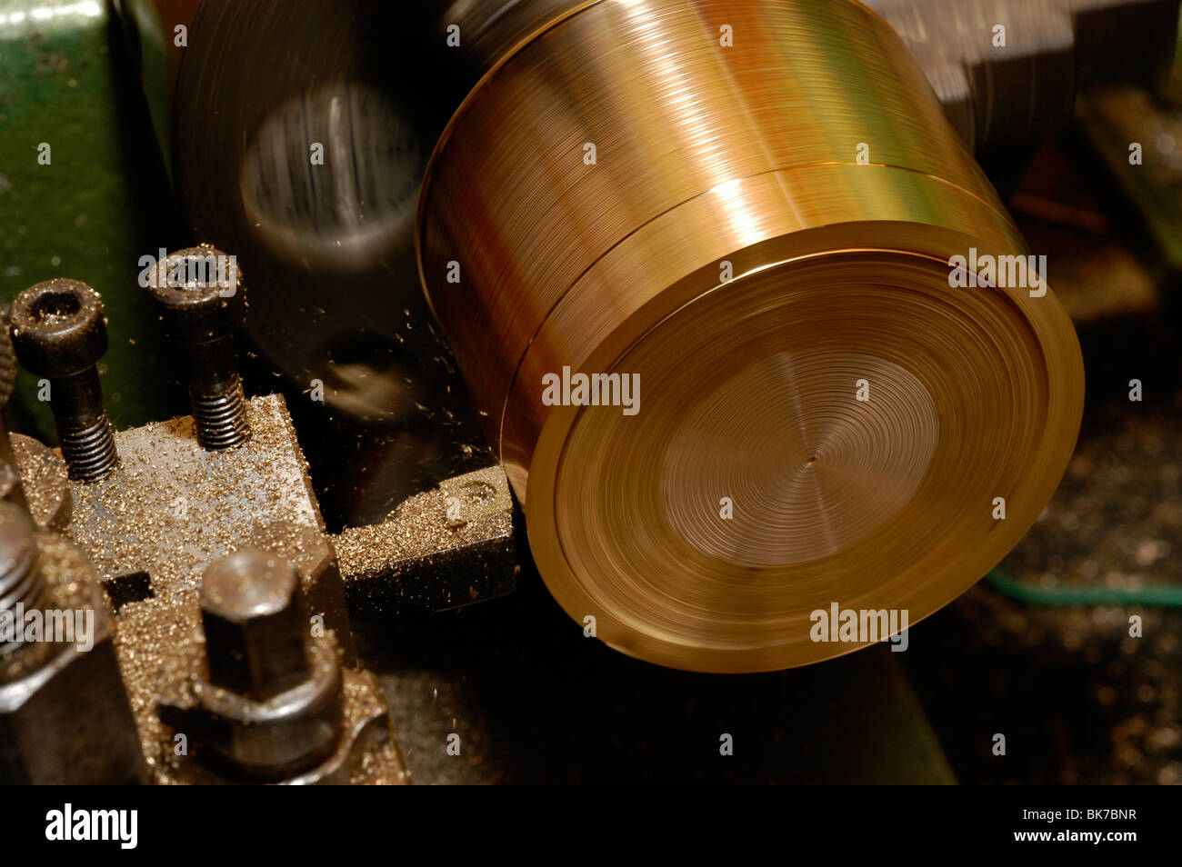 turning a piece of brass bar on a lathe using a knife turning tool Stock Photo Alamy
