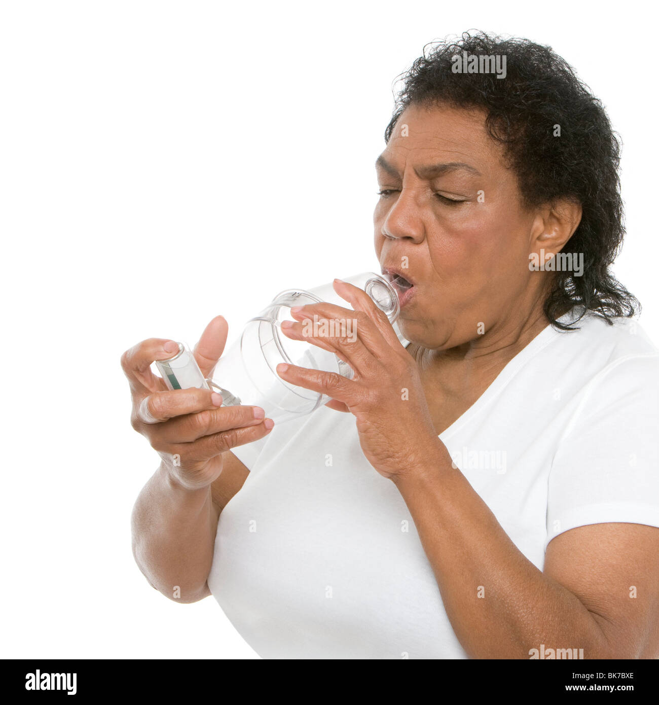 Woman using an asthma spacer Stock Photo