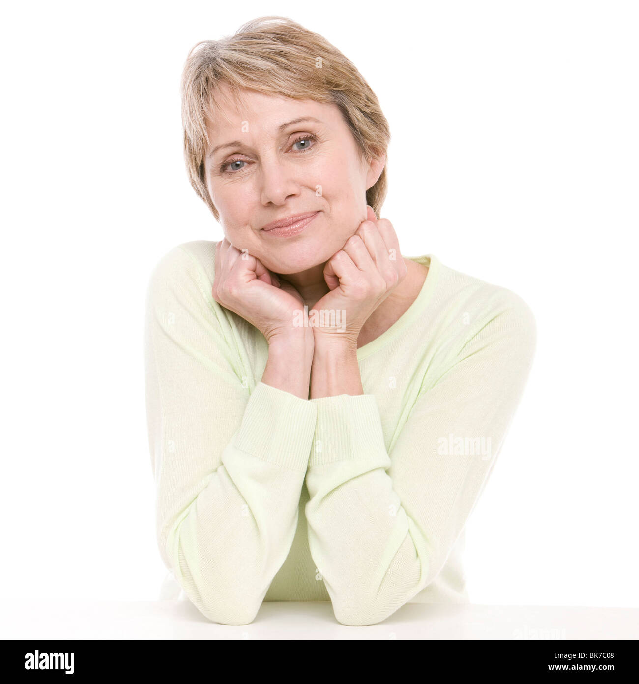 Senior woman smiling sitting hi-res stock photography and images - Alamy