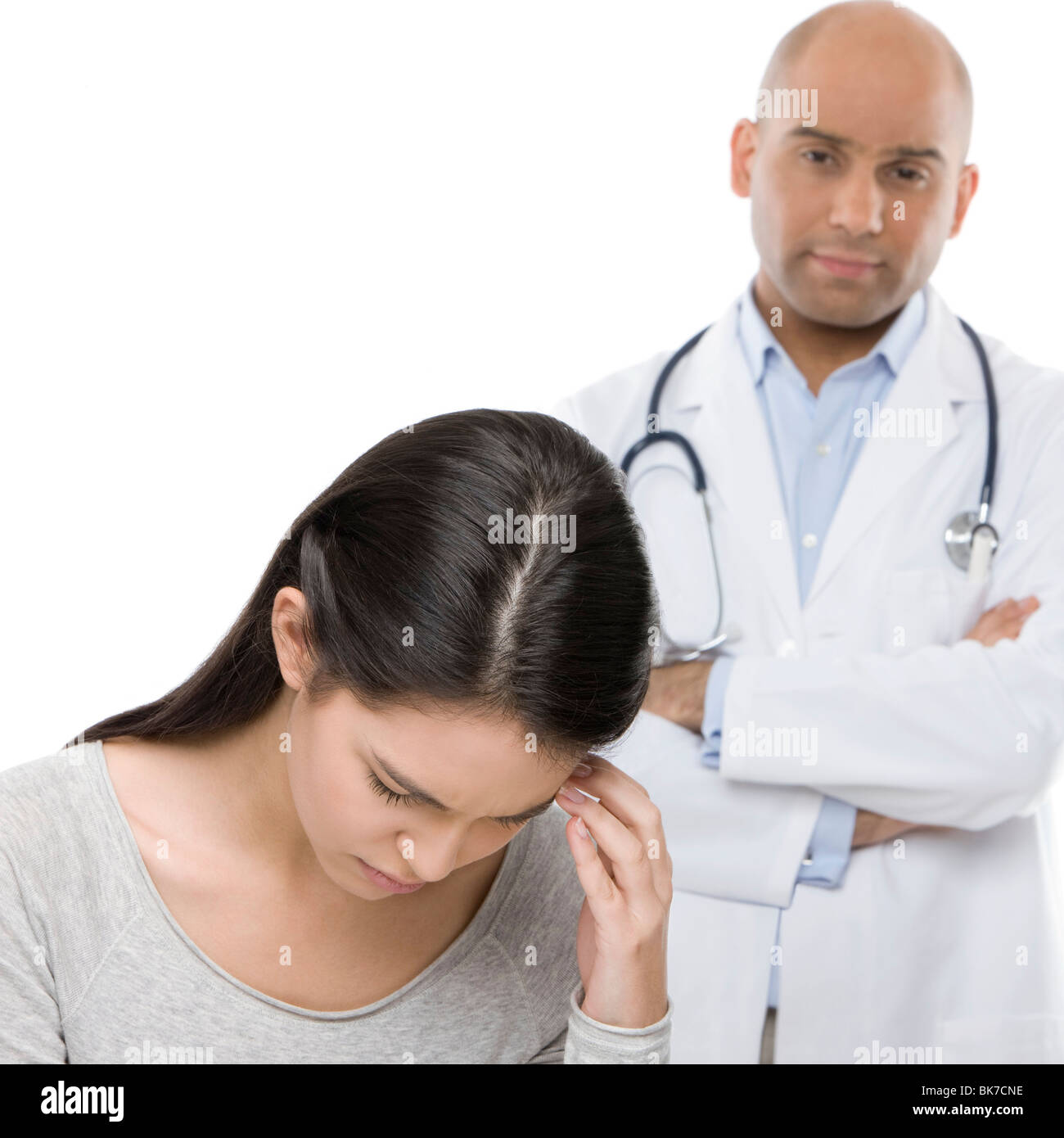 Depressed teenage girl and doctor Stock Photo