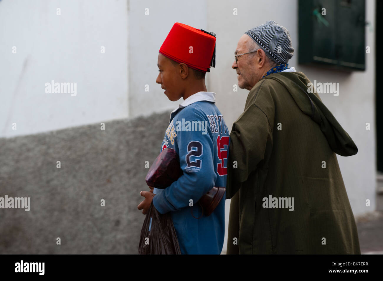 Moroccan kid with typical hat and old man, Tangier, Morocco Stock Photo