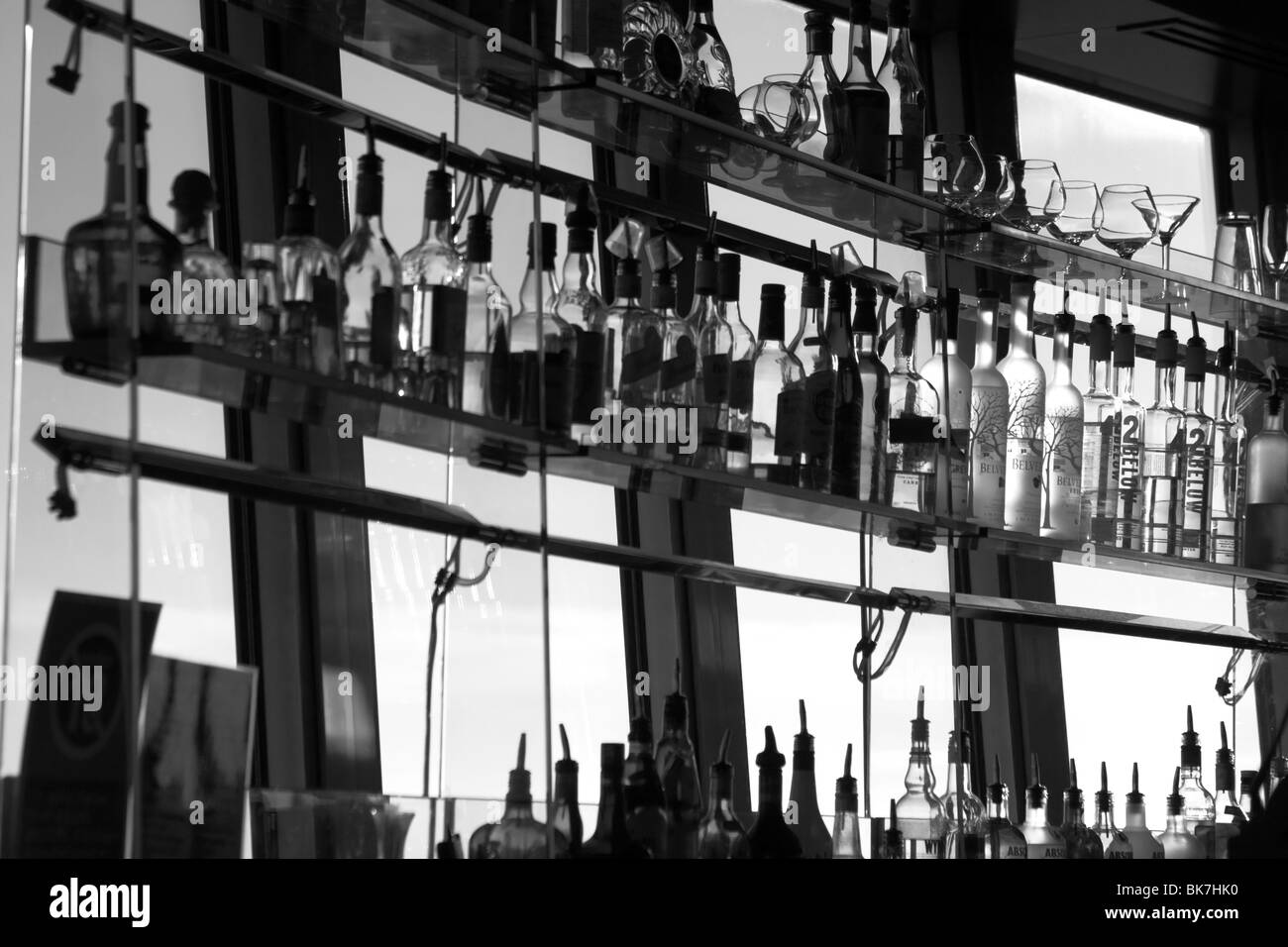 Spirit bottles on bar shelves Stock Photo