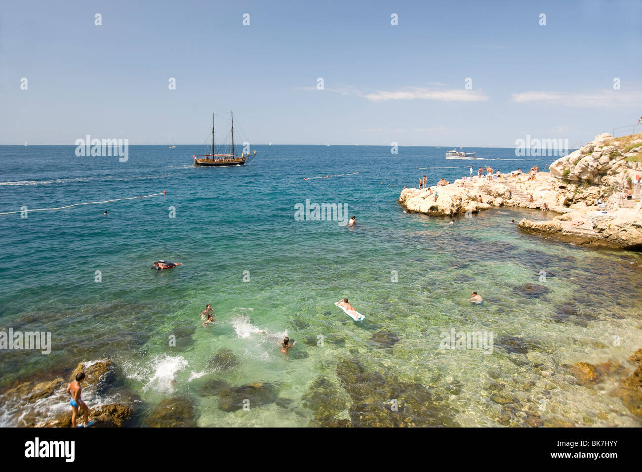 People swimming off the rocky coast at Rovinj, Istria, Croatia, Adriatic, Europe Stock Photo