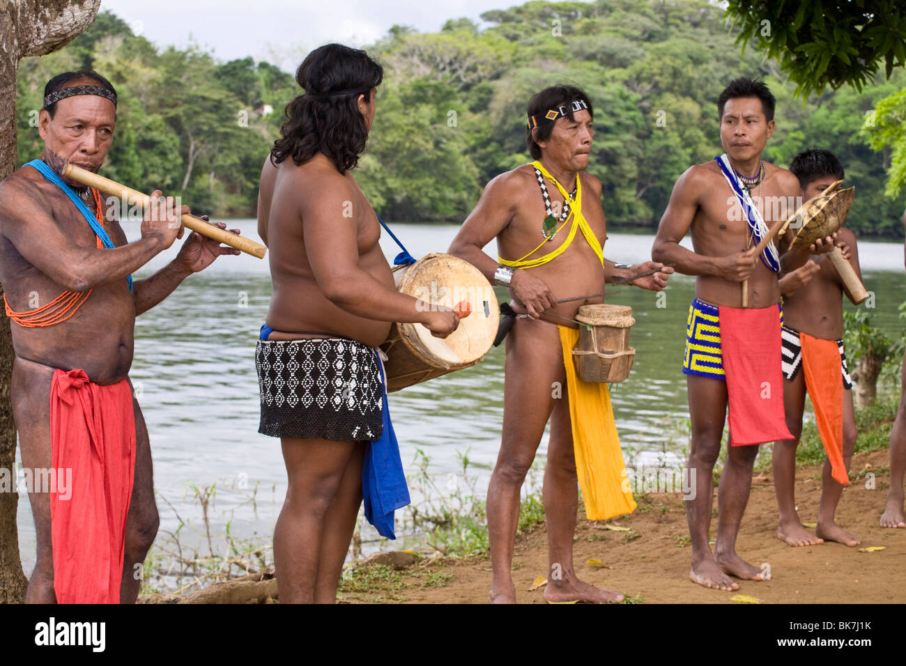 Embara man playing traditional instruments to greet tourists to their village, Embera Village, Chagres River, Panama Stock Photo
