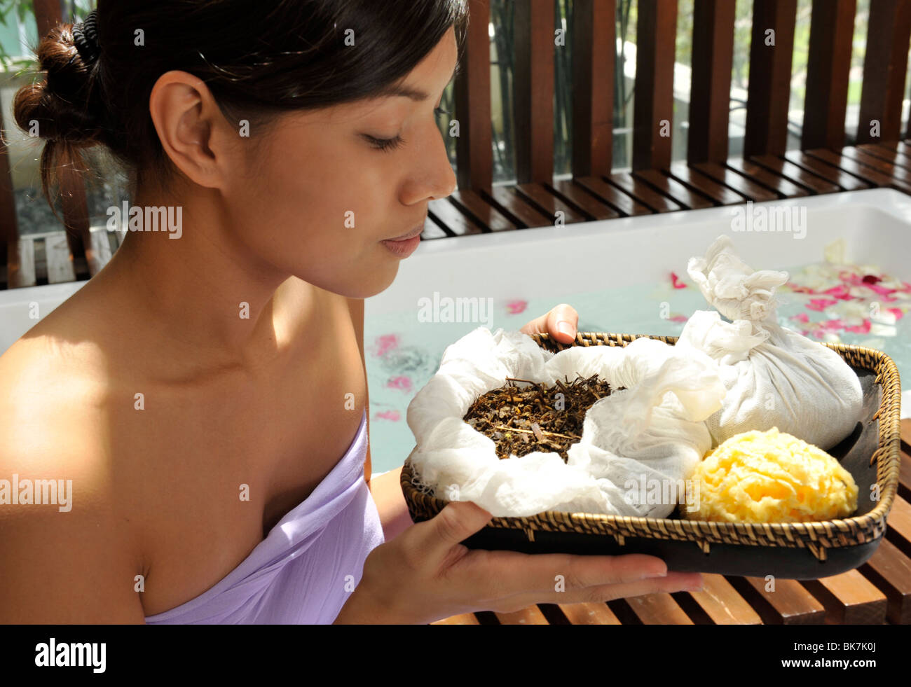 Girl with herbal compress ingredients Stock Photo