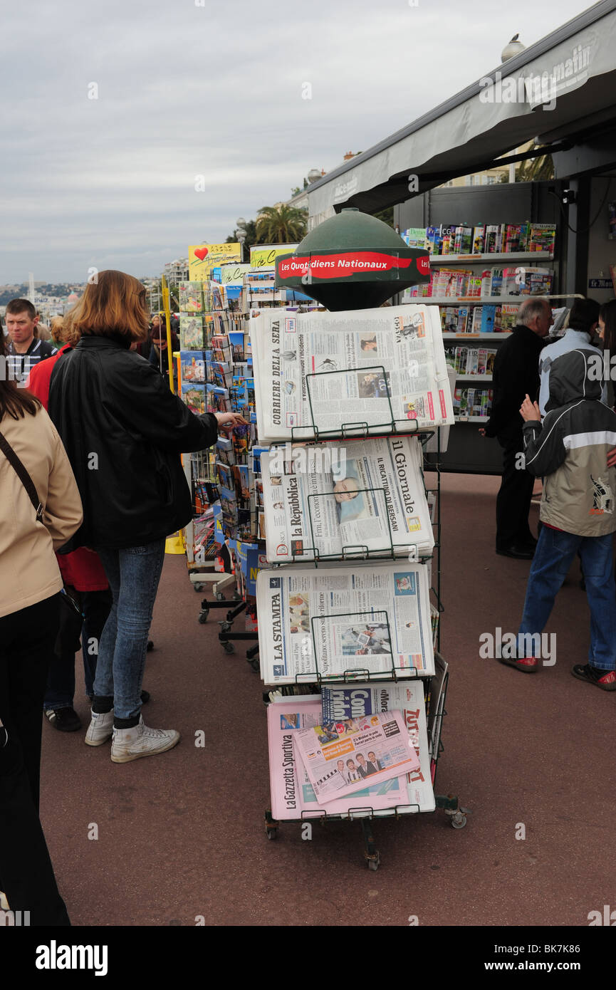 Europe France Nice Cote d'Azur Provence Nice people looking newspapers at a newsstand on the English Promenade Stock Photo