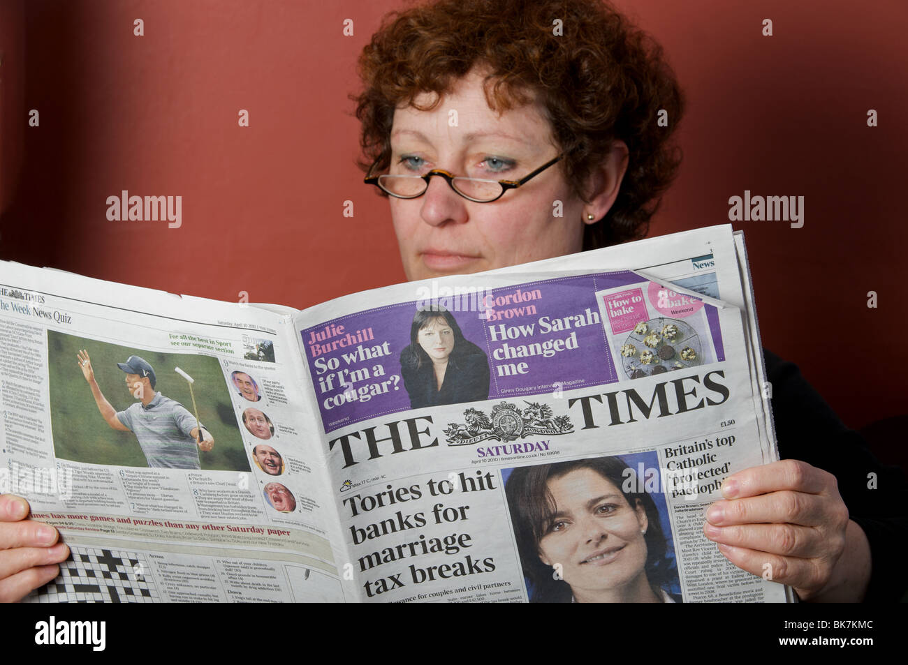 Woman at home reading The Times newspaper Stock Photo