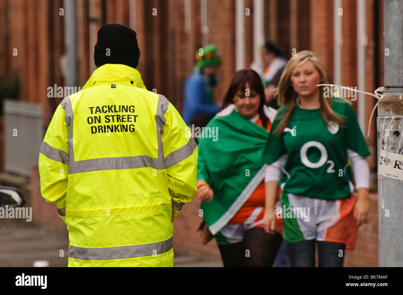 Community worker patrolling Belfast streets, St Patricks' Day, to ensure no alcohol is being consumed. Stock Photo