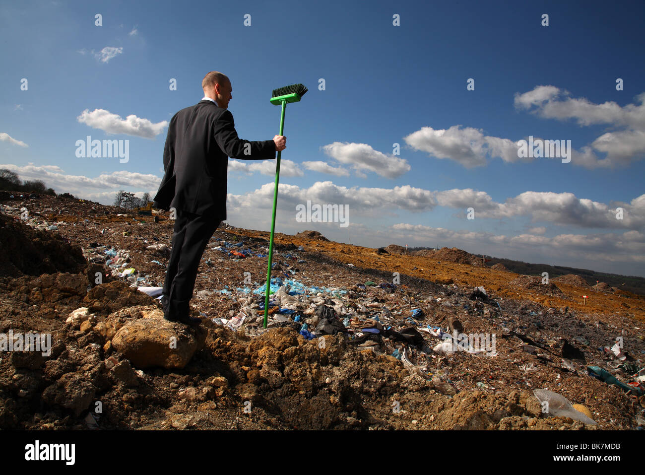 Businessman at british landfill site Stock Photo