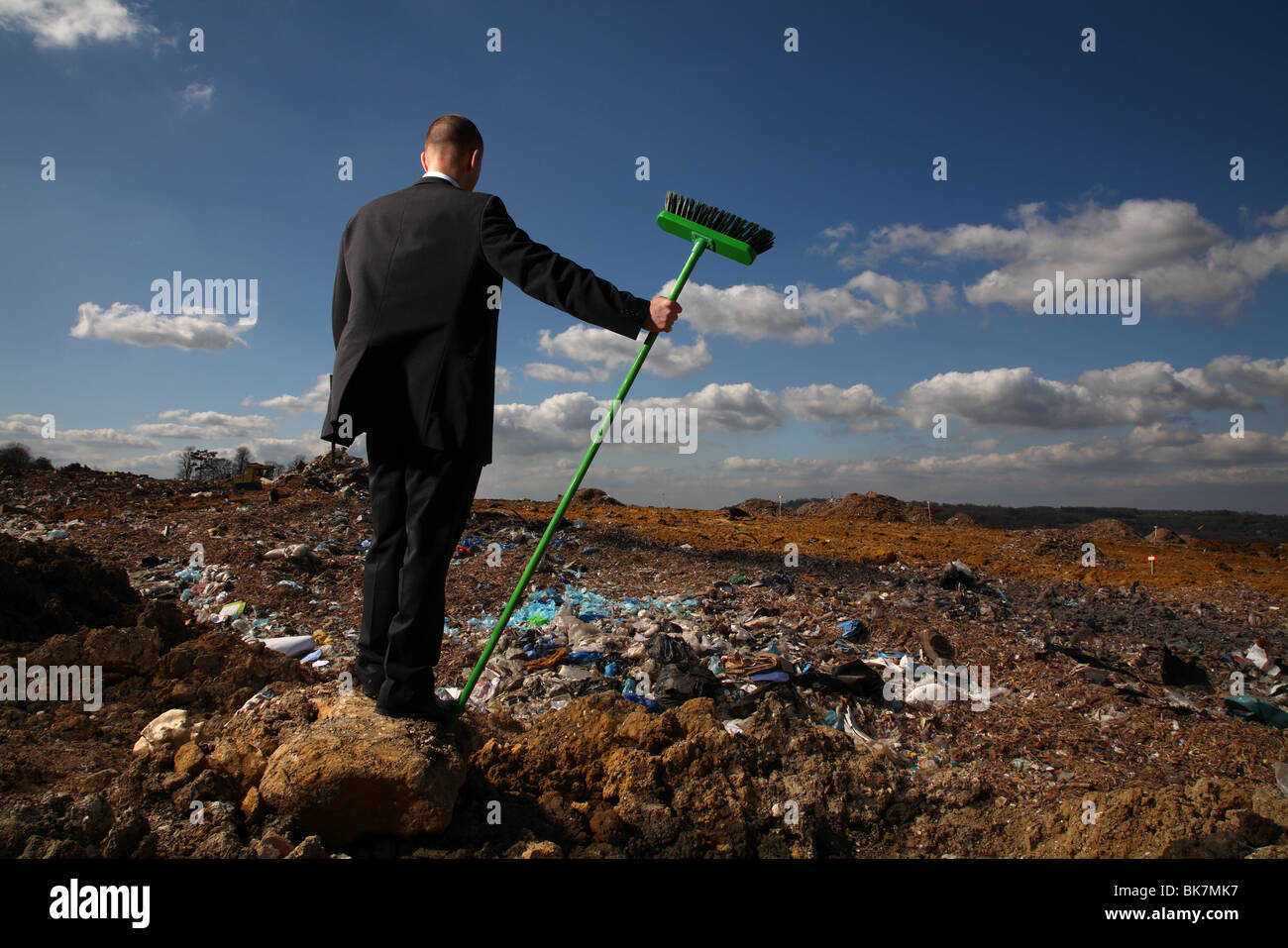 Businessman at british landfill site Stock Photo