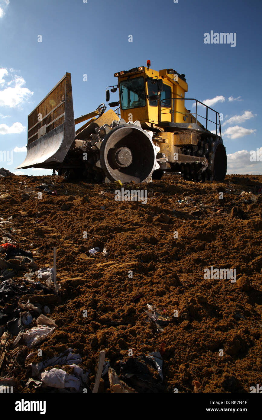 Earth mover on landfill site Stock Photo