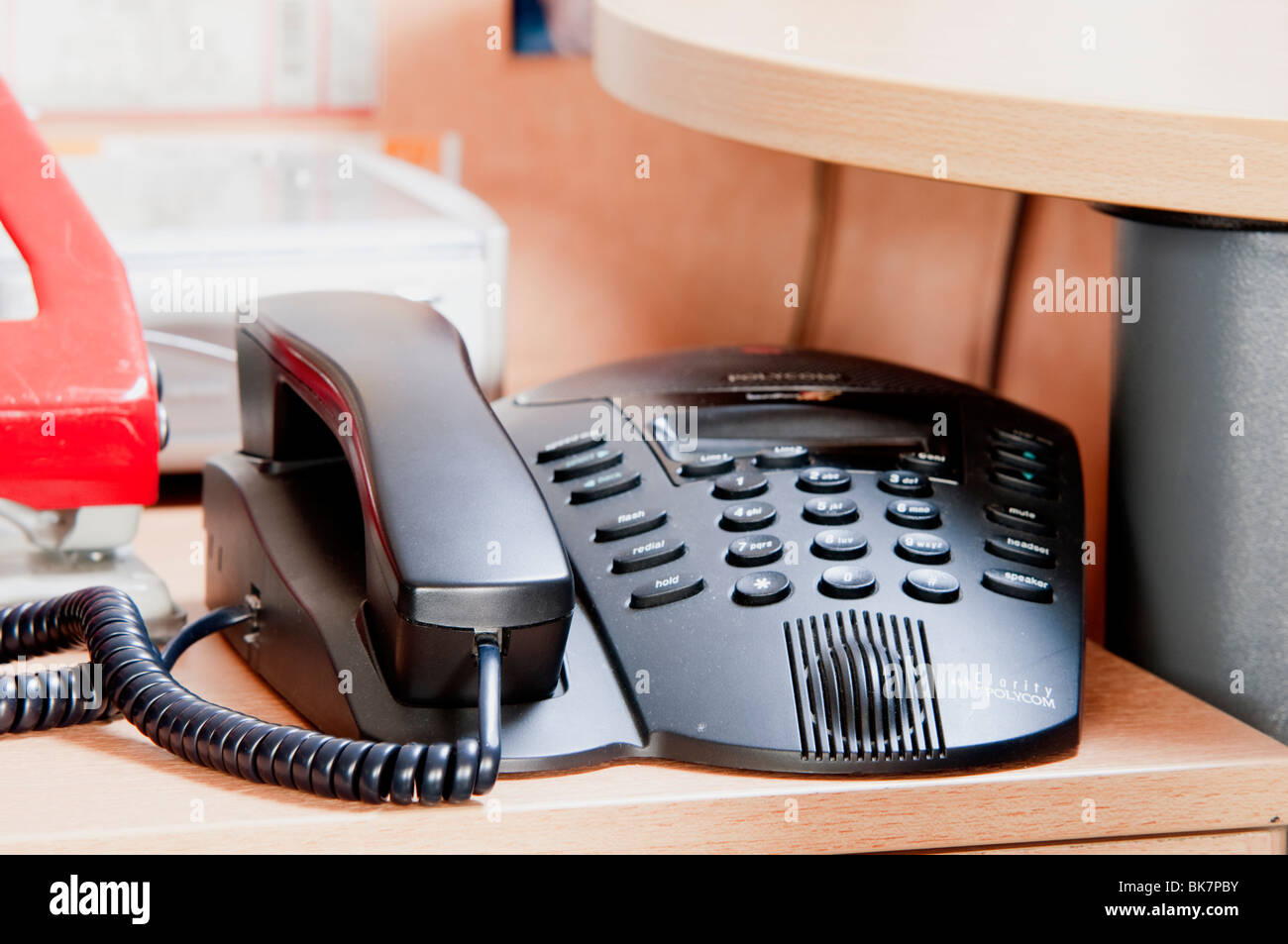 Black office phone on desk Stock Photo - Alamy