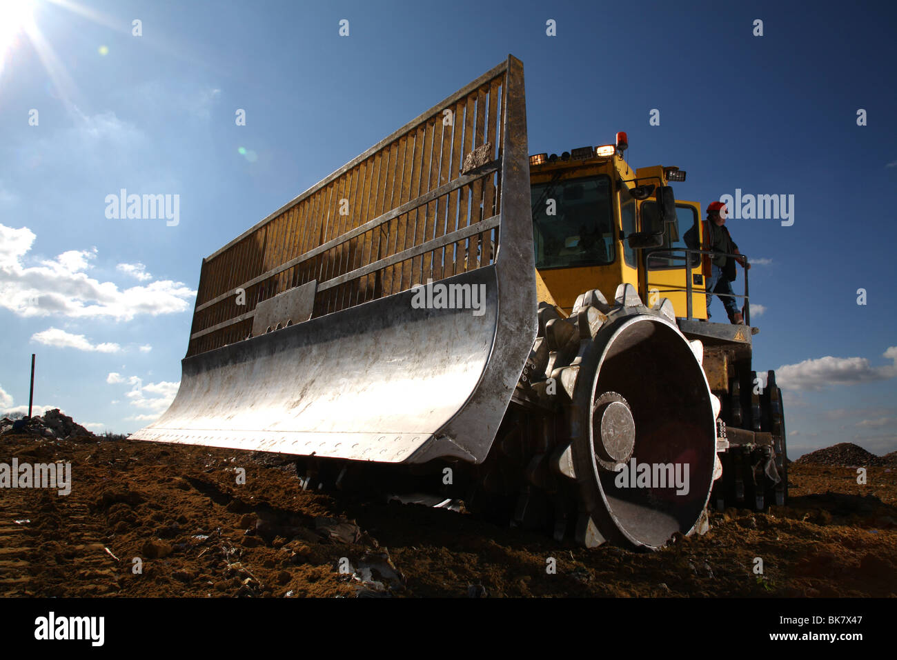 Earth mover on landfill site Stock Photo