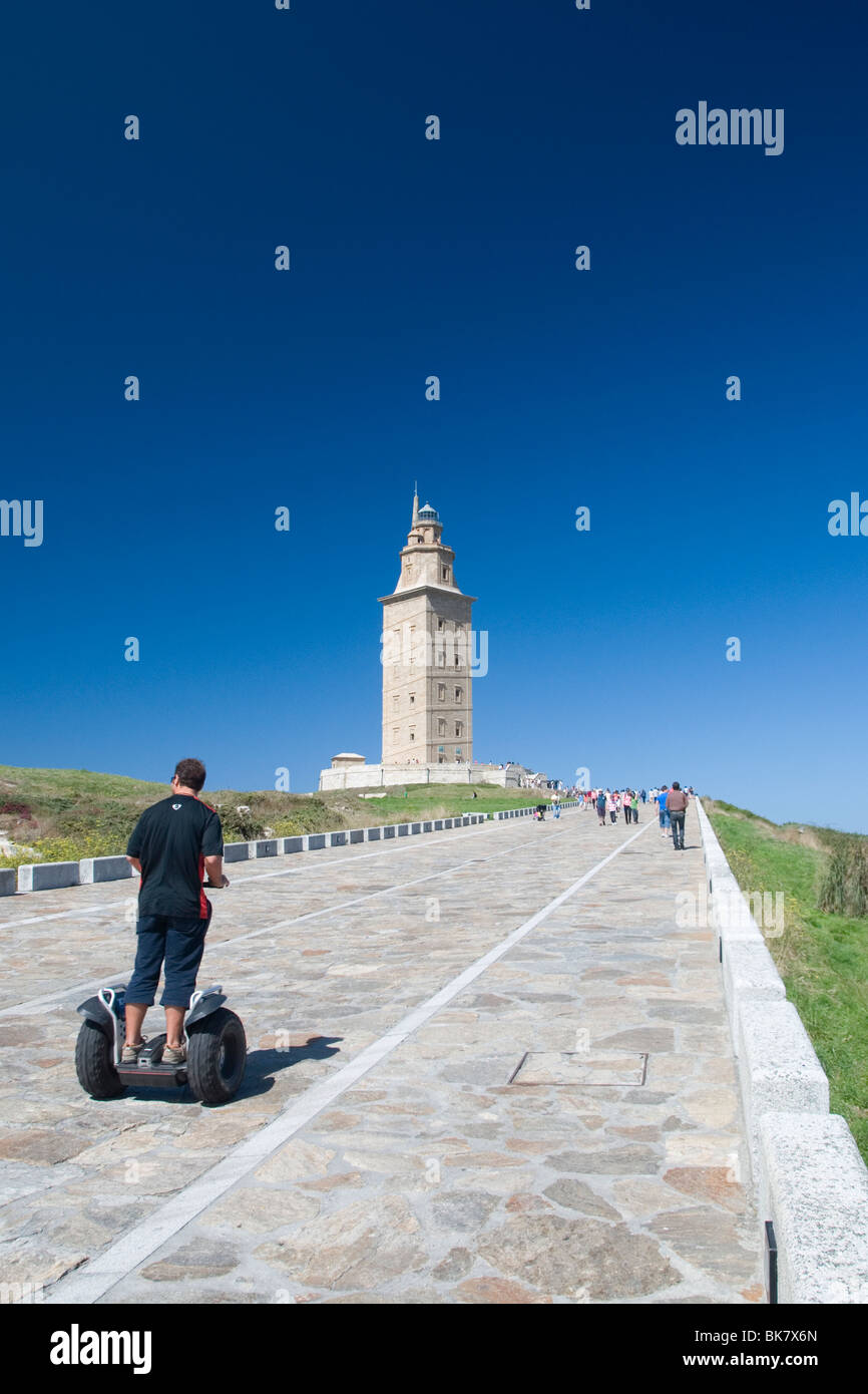 Visitor on a segway approaching the Tower of Hercules in A Coruña, Galicia, Spain Stock Photo