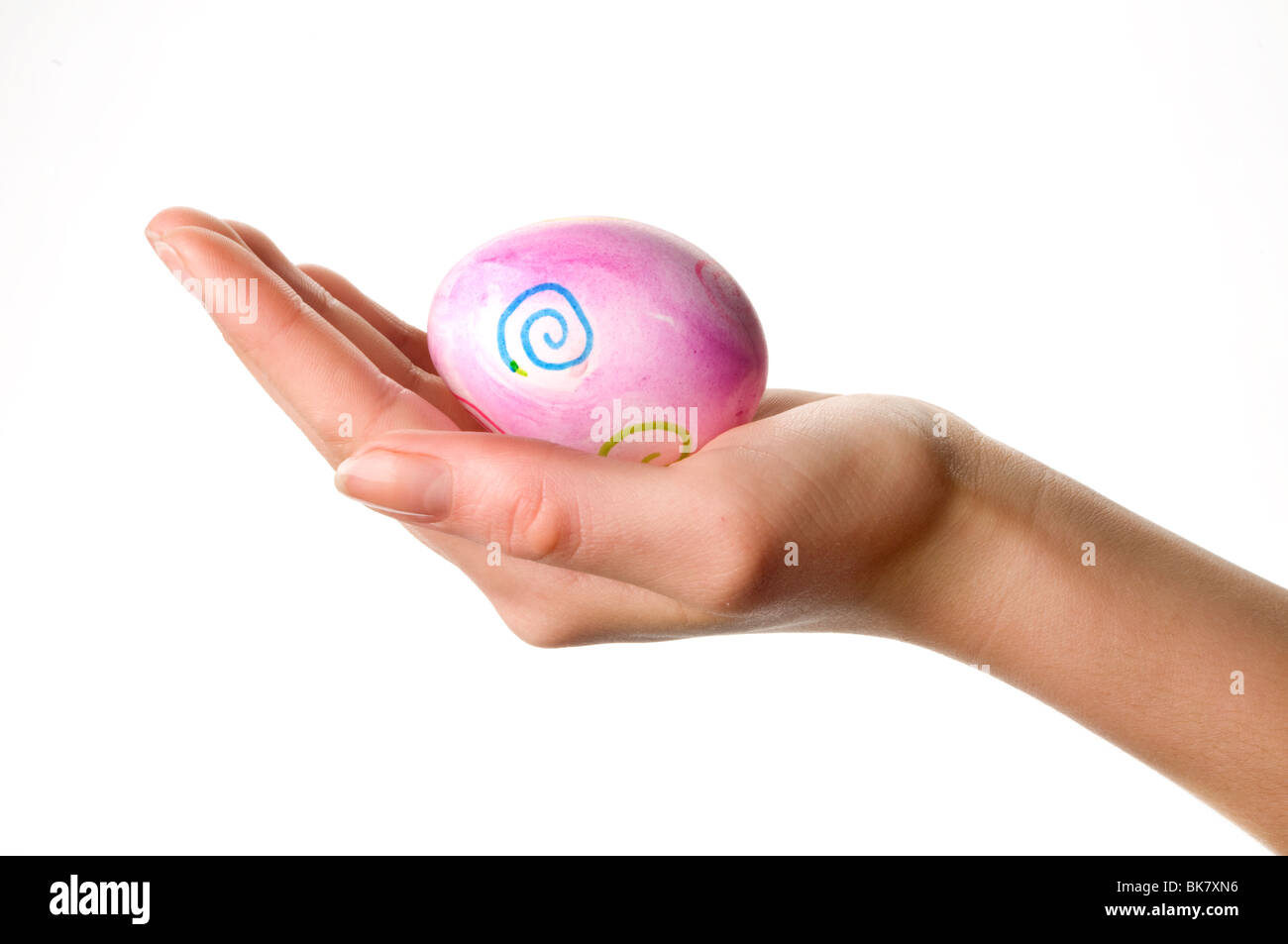 hand holding easter colored egg Stock Photo