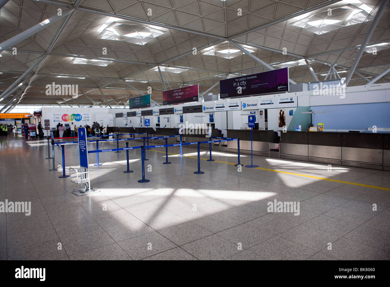 Empty check in desks due to canceled flights inside the terminal of London Stansted airport in Essex Stock Photo