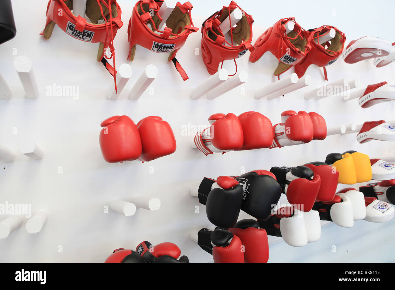 Boxing gloves and head gear at a boxing club gymnasium in the UK Stock Photo