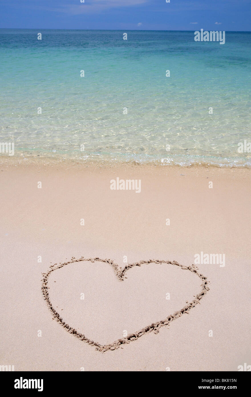 Heart in sand on tropical beach Stock Photo