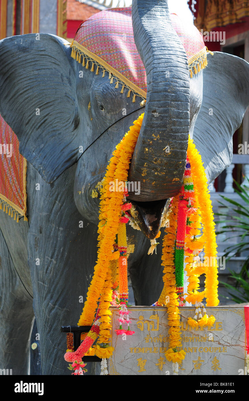 Floral bands on model of an Elephant outside Buddhist temple during the Songkran festival Stock Photo