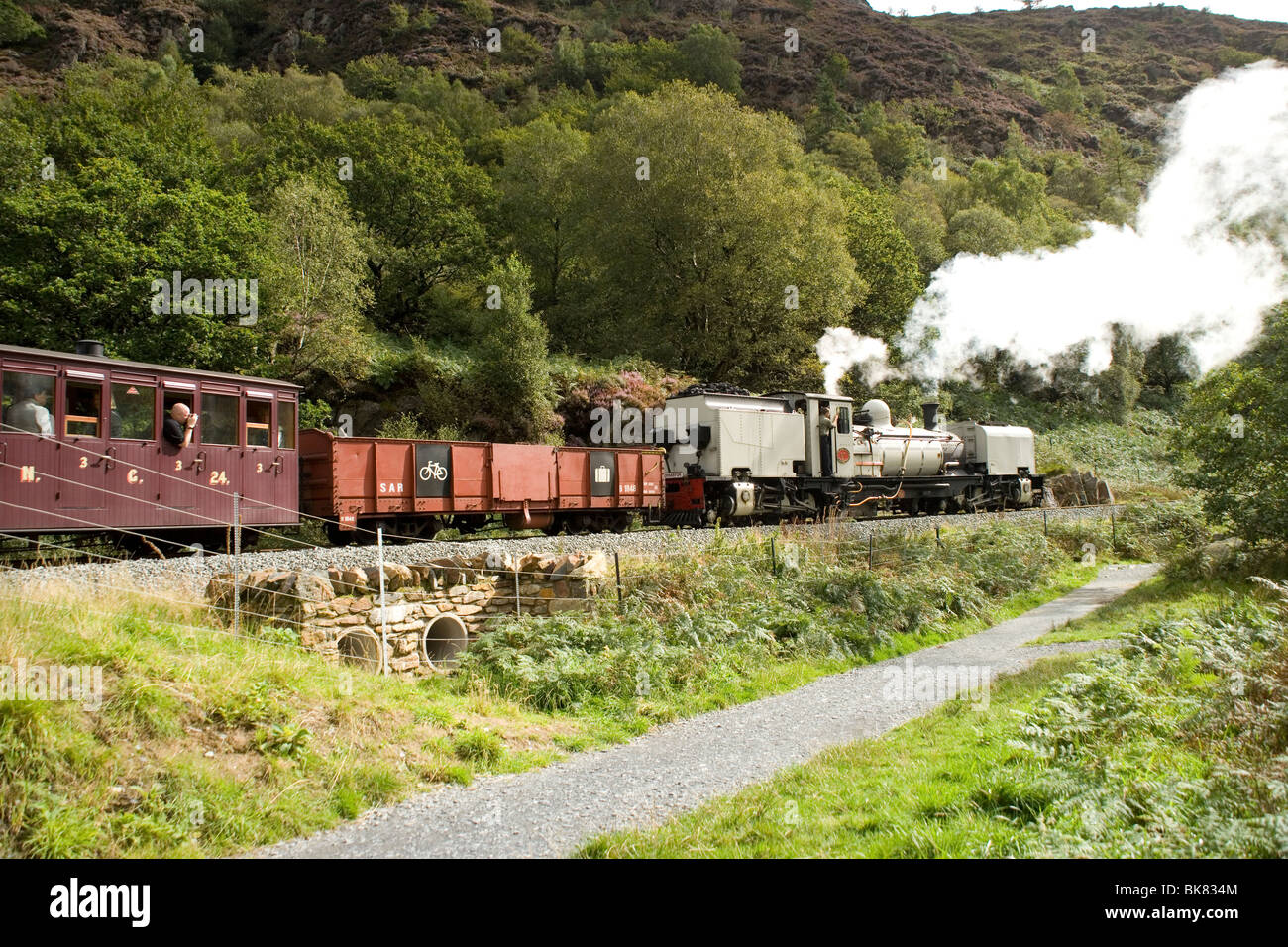 Welsh Highland steam train in the Aberglaslyn pass near Beddgelert and the Glaslyn river,Snowdonia Stock Photo