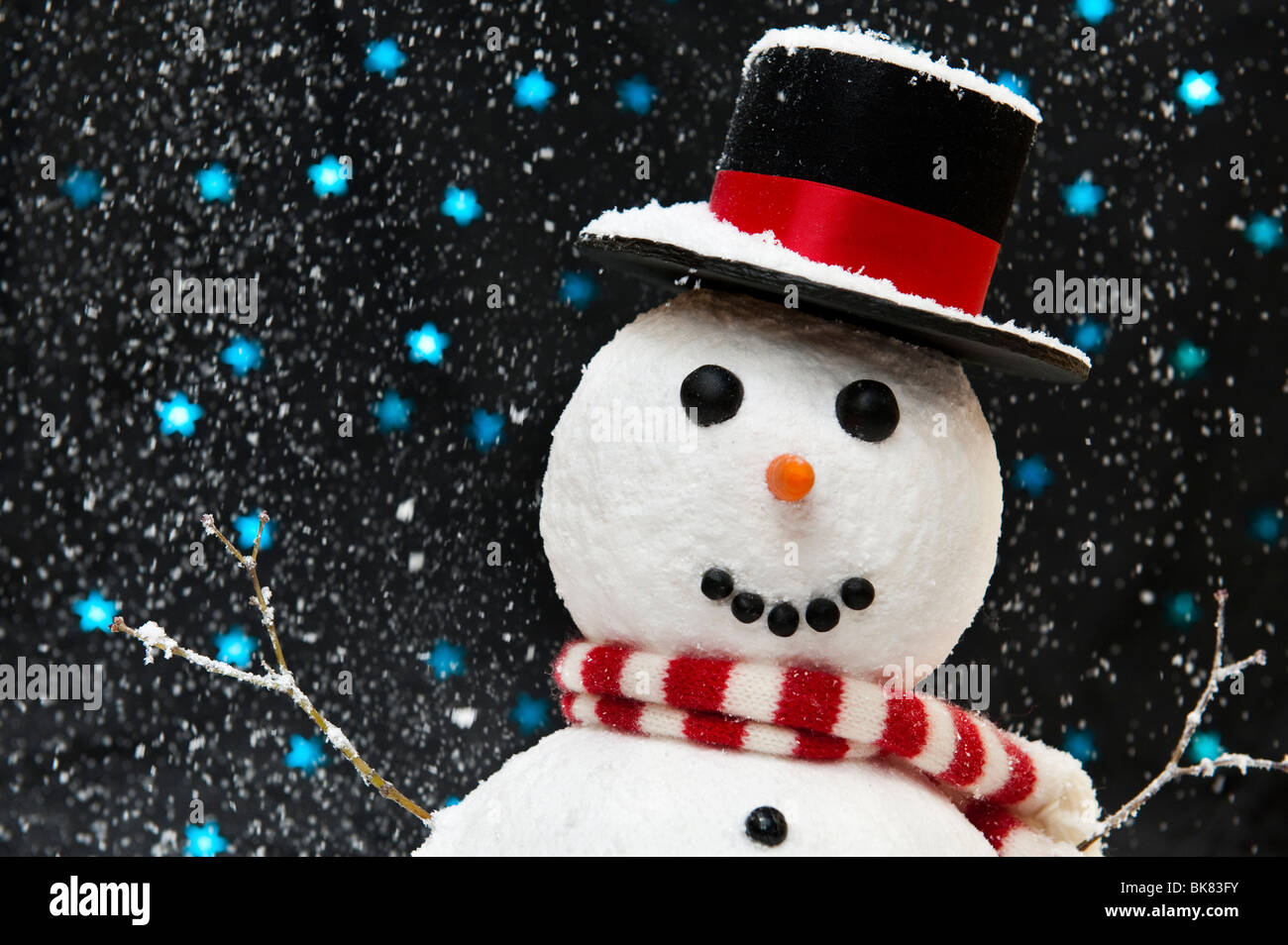 Snowman in the snow against starry night sky concept with copy space ...