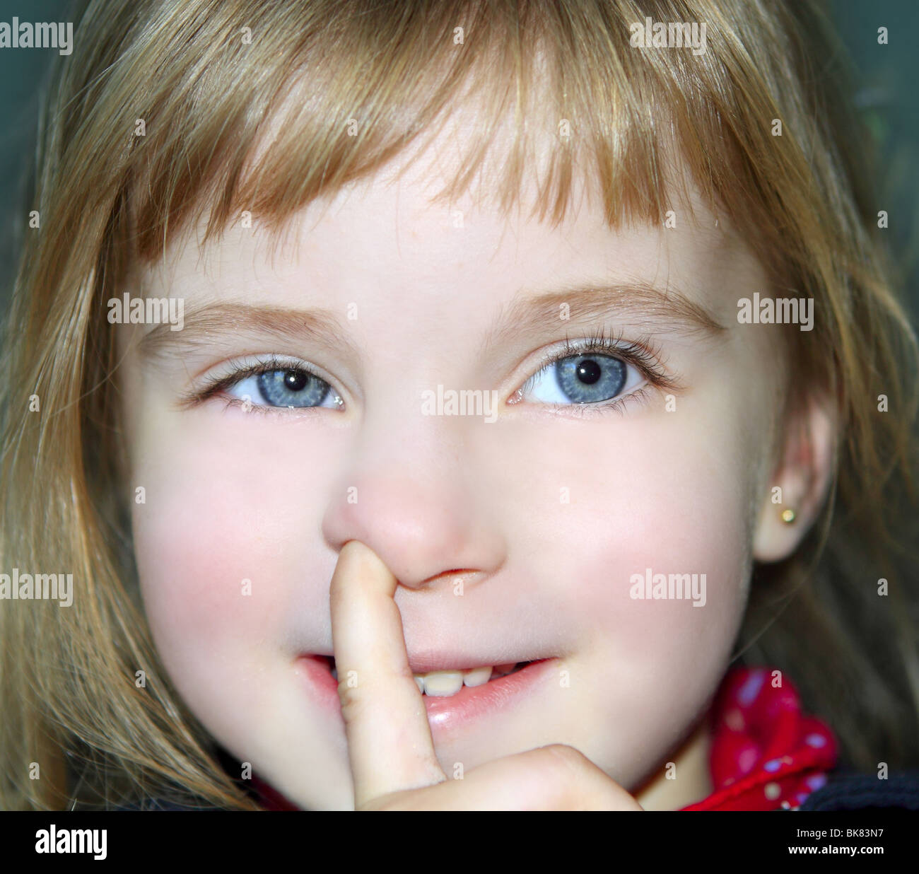blond little girl portrait finger in nose gesture Stock Photo Alamy