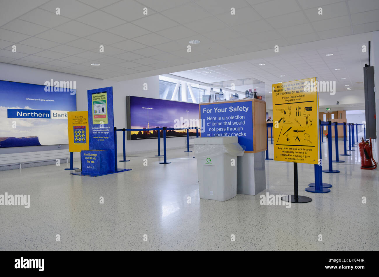 Signs at approach to airport security, warning passengers about prohibited items. Stock Photo