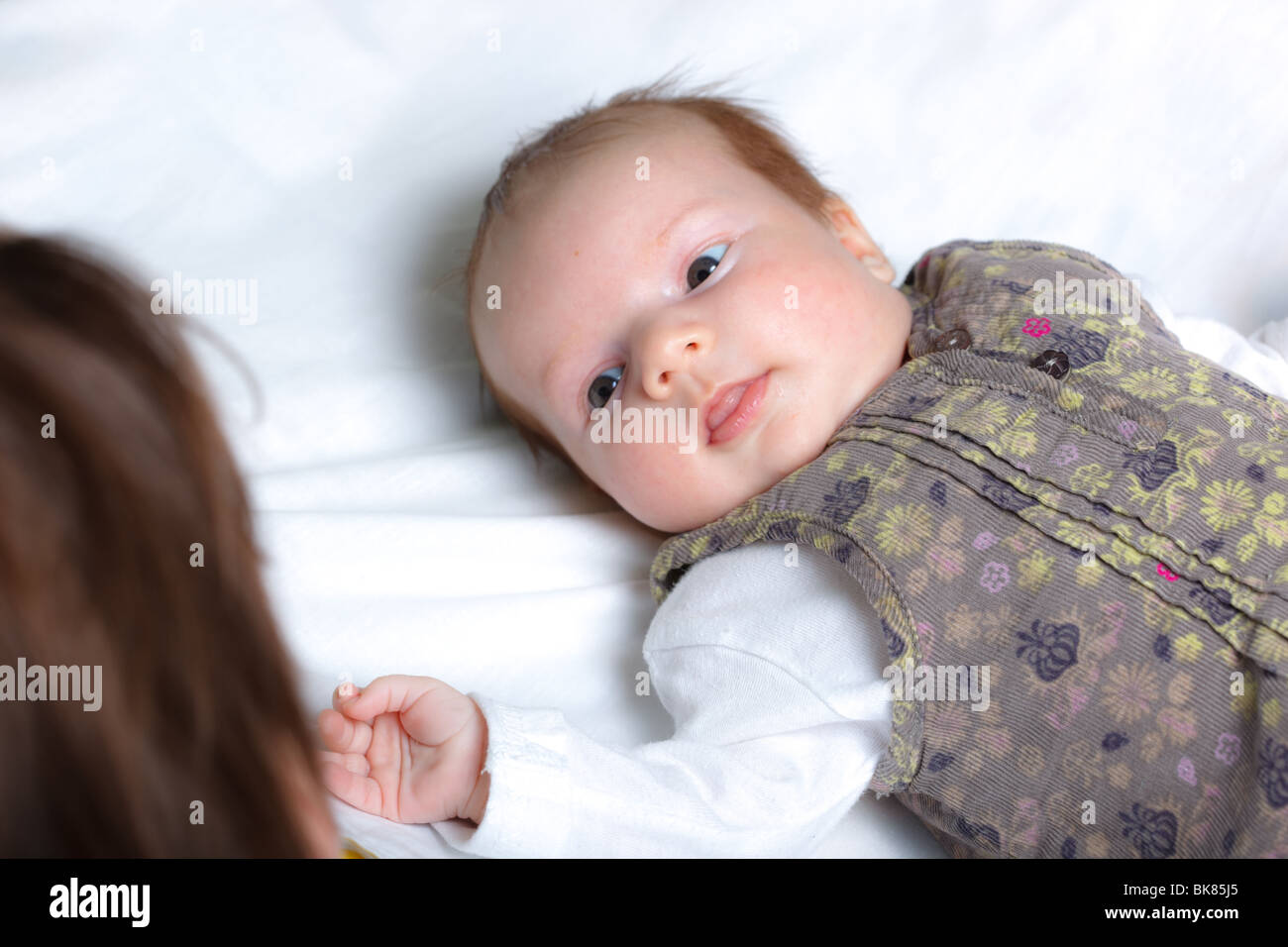 A nice small baby curiously looking around Stock Photo