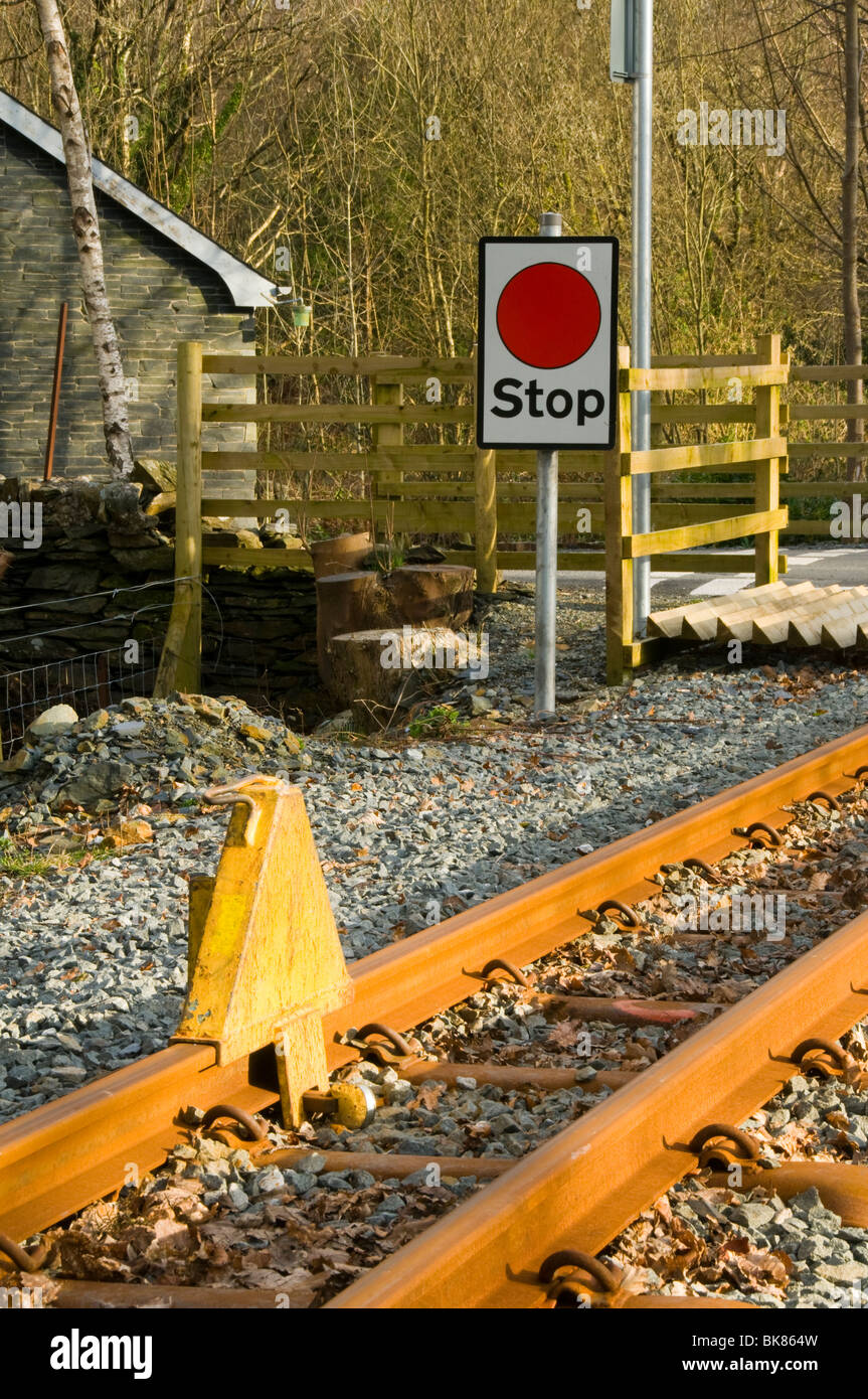 Stop chock or stop block and sign at a level crossing, Welsh Highland Railway, Nantmor, Snowdonia, North Wales, UK Stock Photo