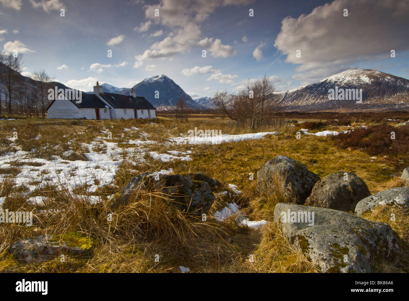Black Rock Cottage sits beside the road that leads to the glencoe ski centre. The mountain behind is Buchaille Etive Mor. Stock Photo