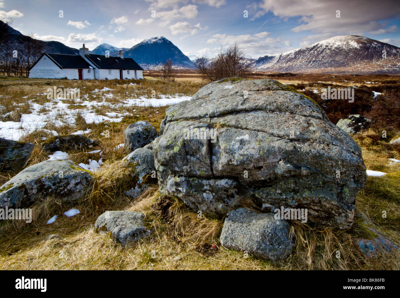 Black Rock Cottage sits beside the road that leads to the glencoe ski centre. The mountain behind is Buchaille Etive Mor. Stock Photo