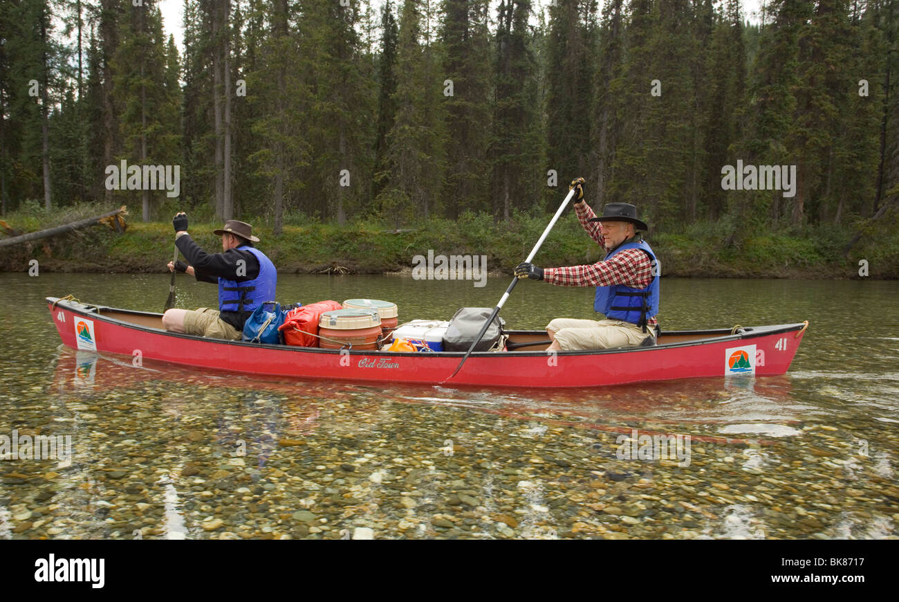 Two men in canoe, paddling, canoeing, clear, shallow water of upper
