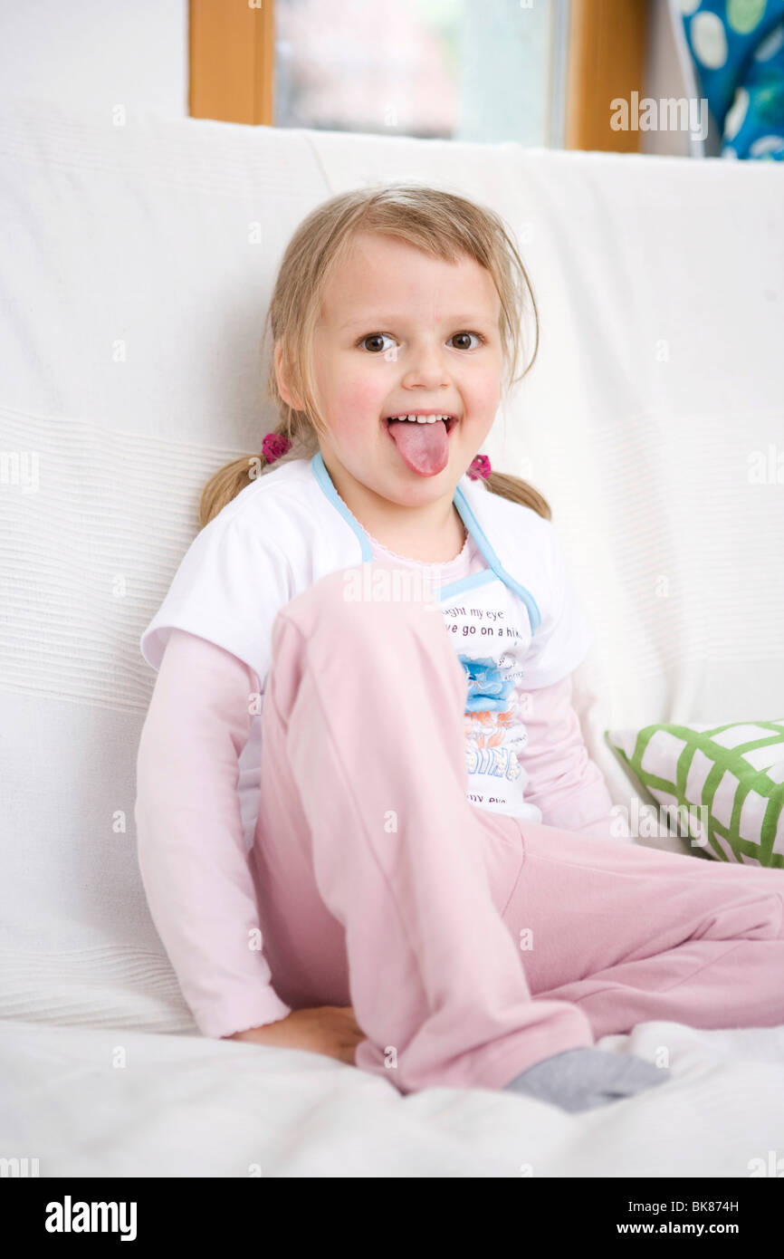 Girl sitting on a sofa Stock Photo